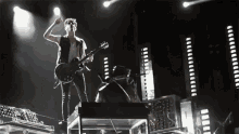 a man is playing a guitar on a stage