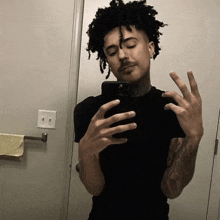 a man taking a selfie with his phone in a bathroom