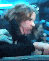 a blurry image of a person using a computer with the letters tk.re on the bottom right