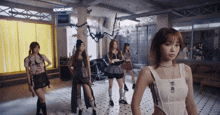 a group of girls standing in front of a sign that says sourcemusic