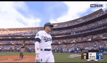 a dodgers player stands on a baseball field during a game
