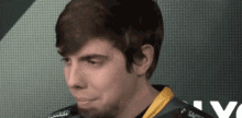 a man with a beard is wearing a black and yellow shirt with the word chess on it