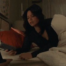 a woman laying on a bed with the words ritualyas on the bottom left