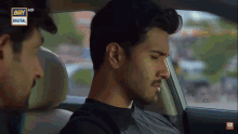 a man sitting in a car with ary digital written on the bottom