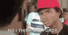 a man wearing a red baseball cap is talking to another man and says `` no i think she purdy ... '' .