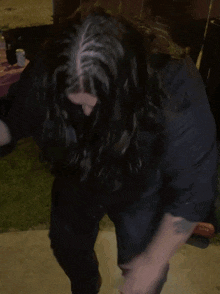 a man in a black shirt is dancing in front of a sign that says ' the bible '