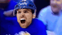 a hockey player wearing a helmet that says ccm is screaming