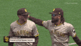 two san diego baseball players standing on the field