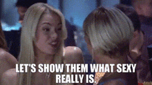 a woman is talking to another woman and the words let 's show them what sexy really is .
