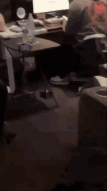 a bottle of water sits on a table in a dark room