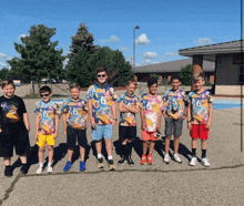 a group of young boys wearing colorful shirts with the number 6 on the front