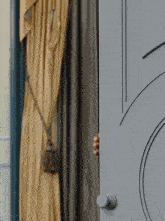 a person peeking out from behind a door with a curtain in the background