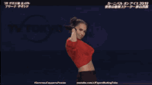 a woman in a red shirt is dancing in front of a sign that says tokyo