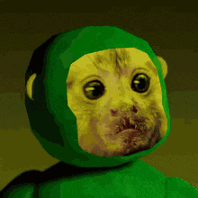 a green monkey with a yellow face is making a funny face