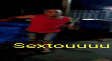 a man in a red tank top is dancing in front of a sign that says sextonuuuu