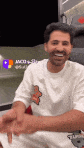 a man wearing a white t-shirt with a sticker on it that says ' supreme '