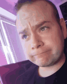 a close up of a man 's face making a funny face