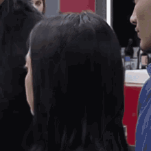a woman is getting her hair cut by a man in a salon .