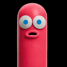 a red cartoon character with blue eyes and a green tongue sticking out .