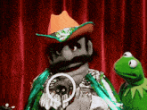 kermit the frog is standing next to a puppet in a cowboy hat