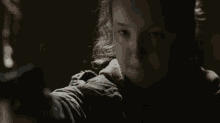 a close up of a girl 's face in the dark