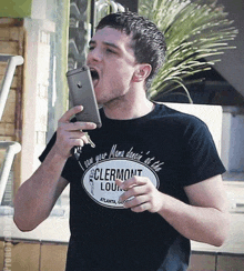 a man wearing a black t-shirt that says clermont lounge on it