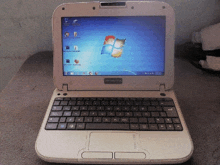 a small white laptop with a windows 7 desktop