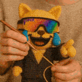 a person is crocheting a stuffed animal with a viper patch on his goggles