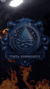 a logo for tirta community with a drop of water on it