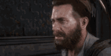 a man with a beard is wearing a white shirt and a backpack