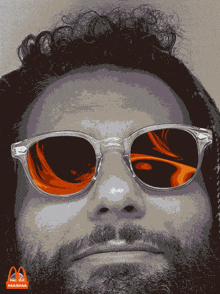 a close up of a man 's face wearing sunglasses with magma on the bottom right