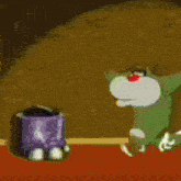 a cartoon cat with a red nose is laying on the ground and looking at the camera .