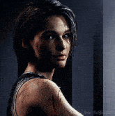 a close up of a woman 's face with the words andy ackles on the bottom right