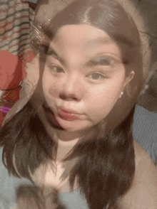 a blurry picture of a girl 's face with a butterfly on her head