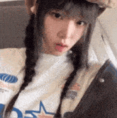 a girl with braids is taking a selfie on a plane .