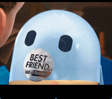 a sticker on a blue object that says " best friend out of the box "