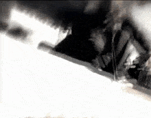 a close up of a person 's foot on a white surface with smoke coming out of it .