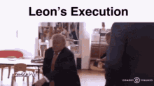 a man in a suit and tie is sitting at a table with the words leon 's execution written on the bottom