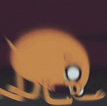 a blurry picture of a cartoon character from adventure time laying on the ground .
