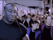 a man wearing headphones is standing in a crowd