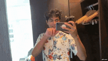 a man taking a picture of himself in a mirror