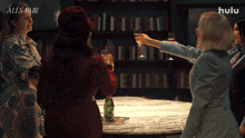 a group of women are toasting with champagne while a bottle of perrier sits on a table