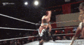 two women are wrestling in a ring with the words gcw london on the bottom