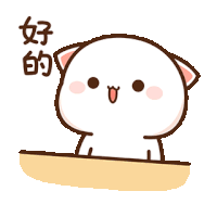 a cartoon cat with chinese writing on it is sitting on a table and smiling .