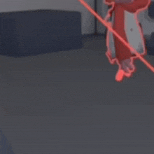 a person is holding a red object in a room with a couch .