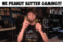 a man in a black playstation shirt says we peanut butter gaming !!!