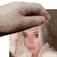 a person is putting a towel on a woman 's head in a pixelated image .