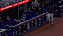 a blue jays player walks to the dugout