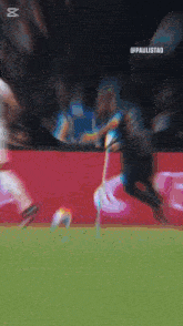 a blurry picture of a soccer game with the word paulistao on the bottom right