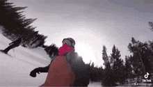 a person is riding skis down a snow covered slope .